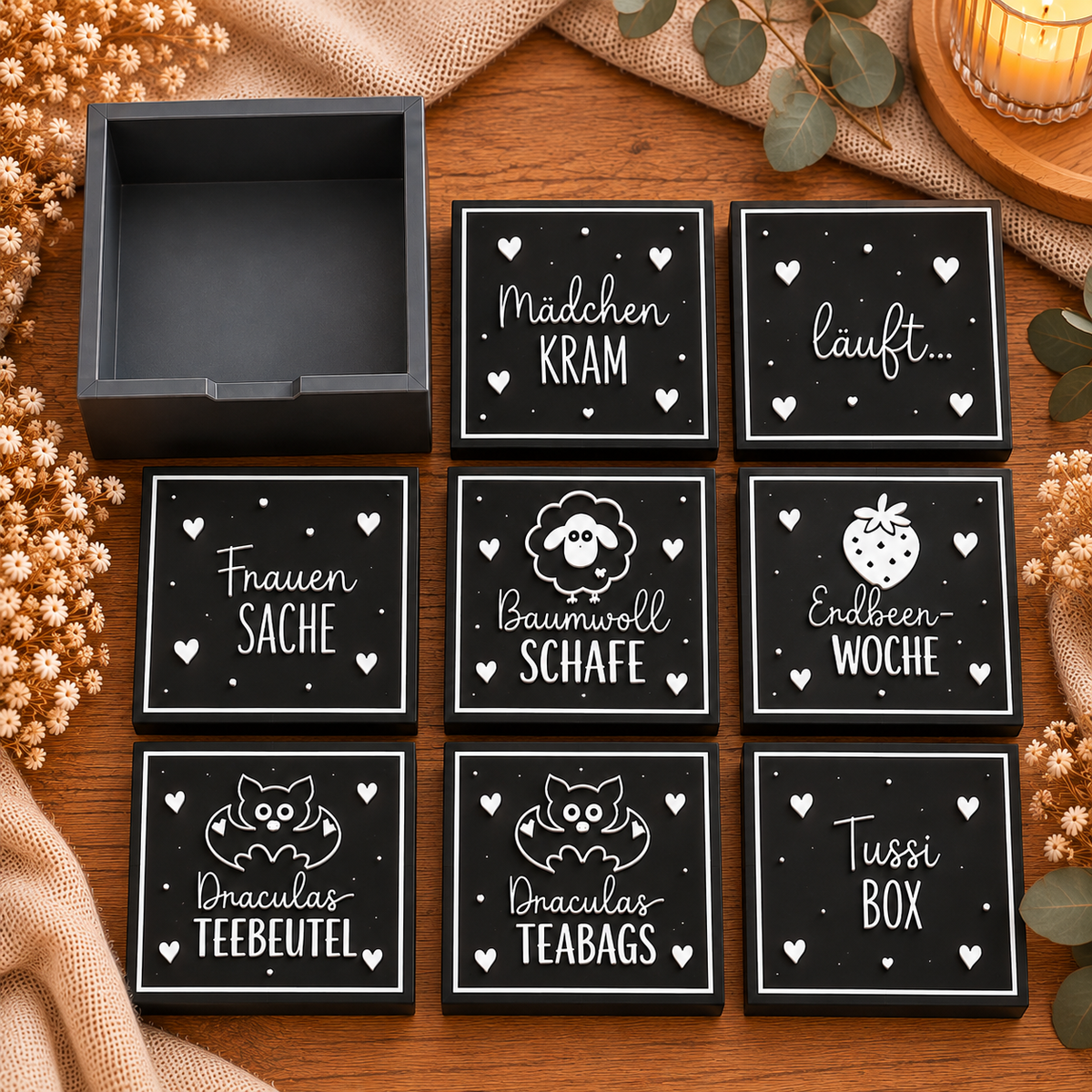 Quadratisches Produktfoto der großen schwarzen Bindenbox mit verschiedenen Deckelmotiven
